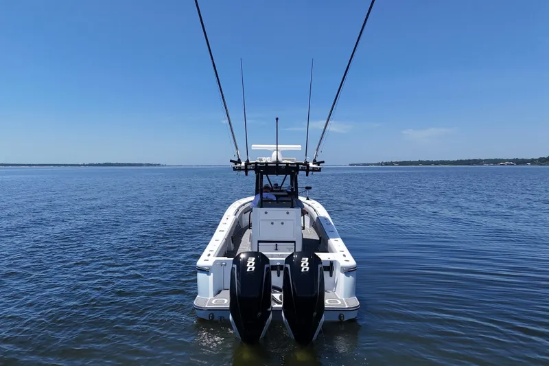 Slide: The Image of 2023 Andros 32 Offshore boat with dual engines on calm water under clear blue sky. - 3