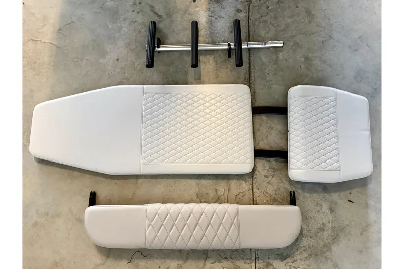 Slide: The Image of 2023 Andros 32 Offshore boat cushions and hardware on concrete floor. - 9
