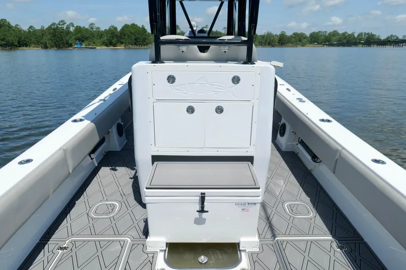 Slide: The Image of 2023 Andros 32 Offshore boat interior with storage and seating on calm water. - 25