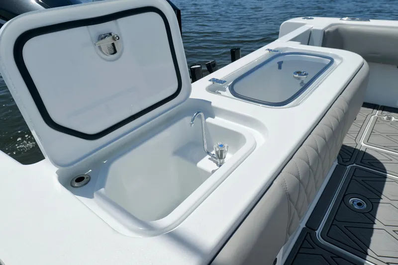 Slide: The Image of 2023 Andros 32 Offshore boat with open storage compartments and seating, on water. - 22