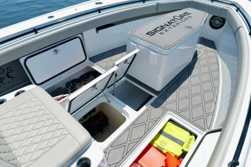 Slide: The Image of 2023 Andros 32 Offshore boat interior with storage compartments and cushioned seating. - 36