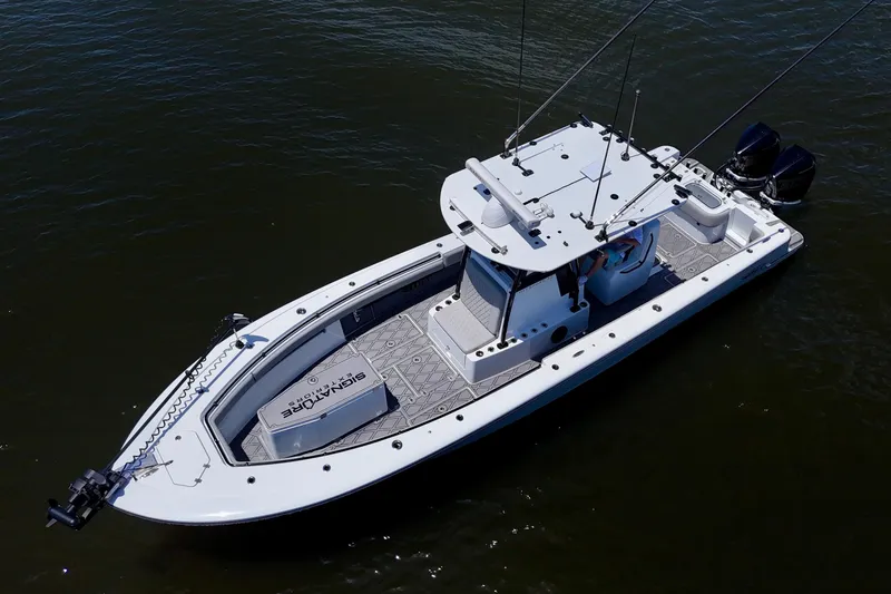 Slide: The Image of 2023 Andros 32 Offshore boat on water, featuring dual engines and spacious deck. - 8