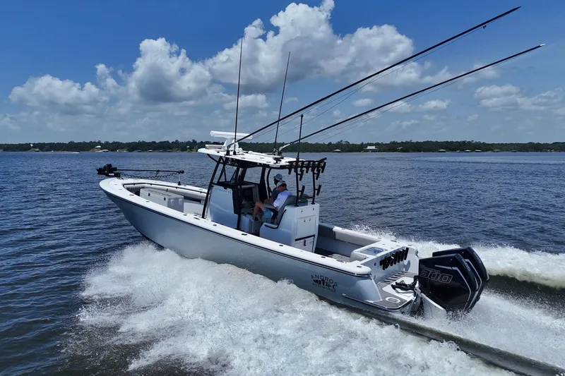 Slide: The Image of 2023 Andros 32 Offshore boat cruising on a sunny day with fishing rods. - 6