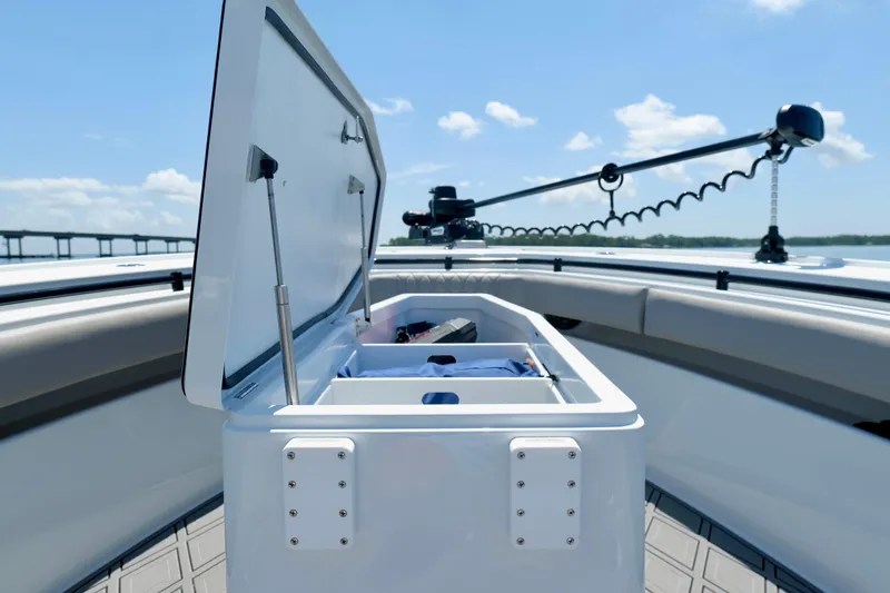 Slide: The Image of Open storage compartment on 2023 Andros 32 Offshore boat under clear blue sky. - 37