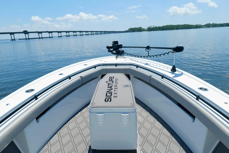 Slide: The Image of 2023 Andros 32 Offshore boat on calm water with bridge in background. - 31