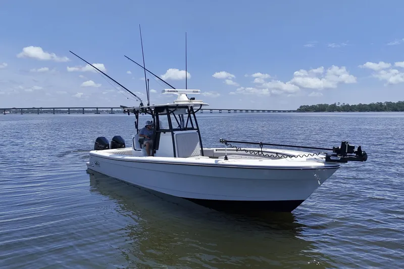 The Image of 2023 Andros 32 Offshore boat on calm water with bridge in background. - 0