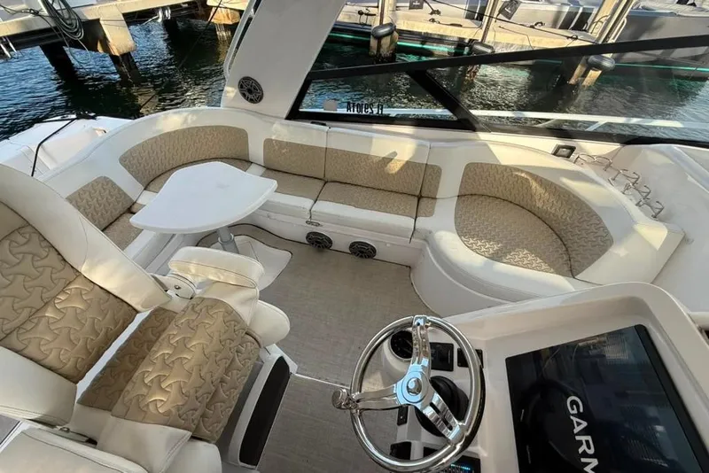 Slide: The Image of Luxurious seating area on a 2021 Intrepid 477 Evolution yacht with elegant upholstery and helm. - 2