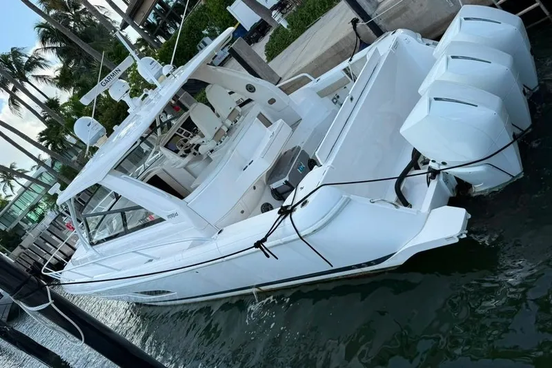 Slide: The Image of 2021 Intrepid 477 Evolution boat docked, featuring sleek design and powerful engines. - 18