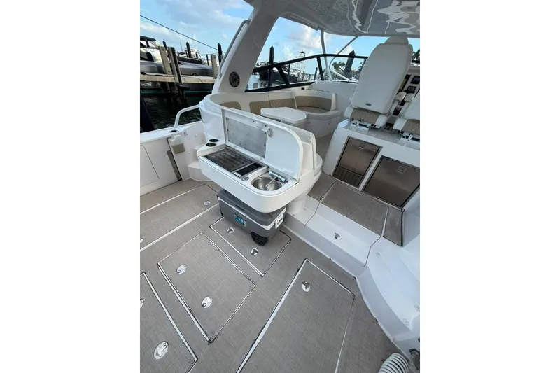 Slide: The Image of 2021 Intrepid 477 Evolution boat interior with seating and kitchenette area. - 4