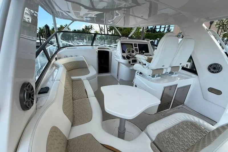 Slide: The Image of 2021 Intrepid 477 Evolution boat interior with plush seating and modern helm controls. - 3