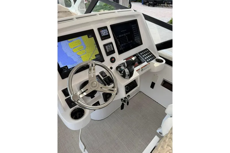 Slide: The Image of Helm of 2021 Intrepid 477 Evolution with navigation screens and controls. - 8