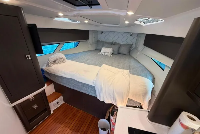 Slide: The Image of Luxurious cabin interior of 2021 Intrepid 477 Evolution yacht with cozy bedding. - 11