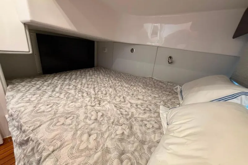 Slide: The Image of Cozy cabin bed in 2021 Intrepid 477 Evolution yacht, featuring elegant bedding and modern design. - 13