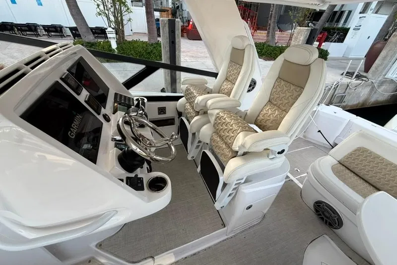 Slide: The Image of Helm of 2021 Intrepid 477 Evolution with luxurious seating and advanced navigation controls. - 1
