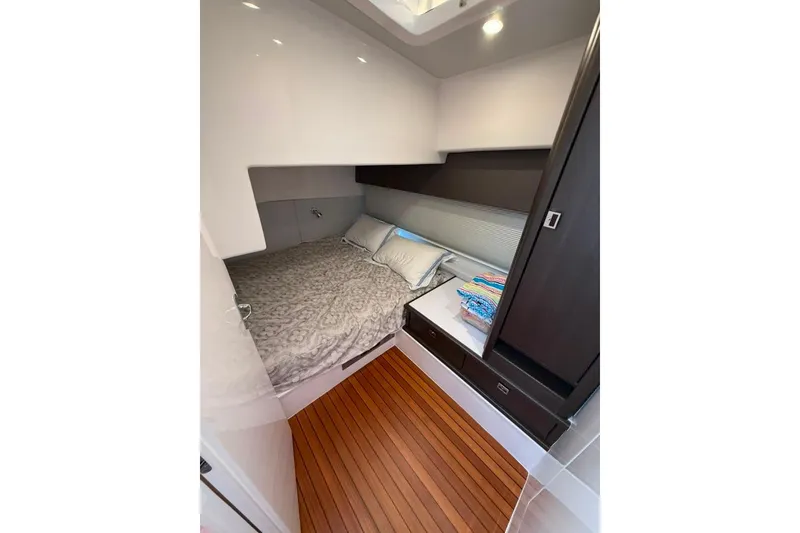 Slide: The Image of Luxurious cabin interior of 2021 Intrepid 477 Evolution yacht with cozy bedding. - 16
