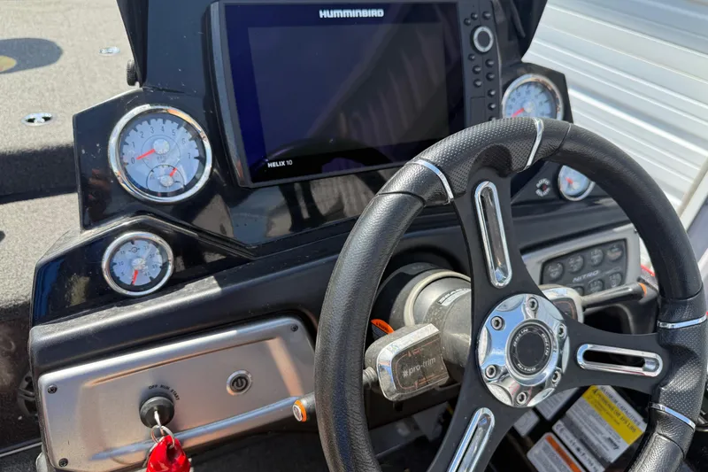 Slide: The Image of Steering wheel and dashboard of a 2021 Nitro Z20 boat with gauges and Humminbird display. - 98