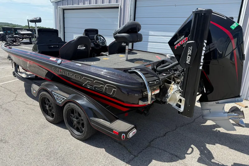 Slide: The Image of 2021 Nitro Z20 boat with Mercury Pro engine, parked outside a garage. - 82