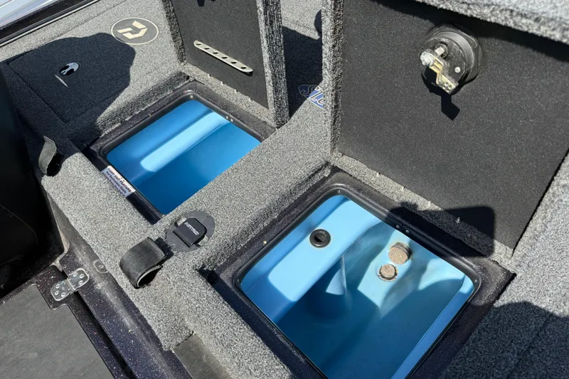 Slide: The Image of 2021 Nitro Z20 boat storage compartments with blue interior and carpeted exterior. - 105