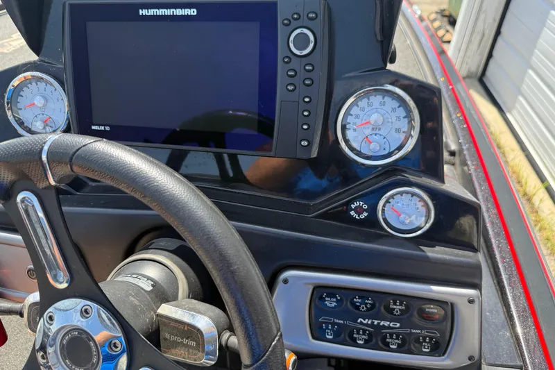 Slide: The Image of Dashboard of a 2021 Nitro Z20 boat with steering wheel and control panel. - 99