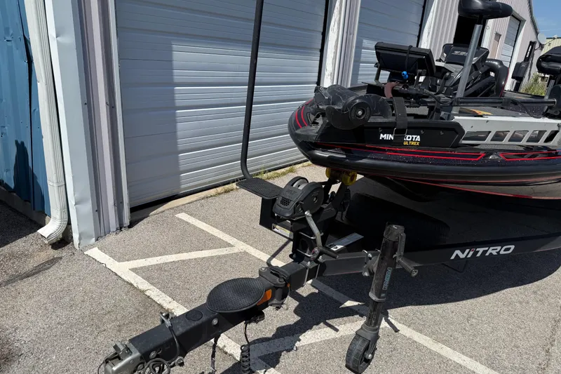 Slide: The Image of 2021 Nitro Z20 boat with Minn Kota Ultrex motor parked outside a garage. - 89