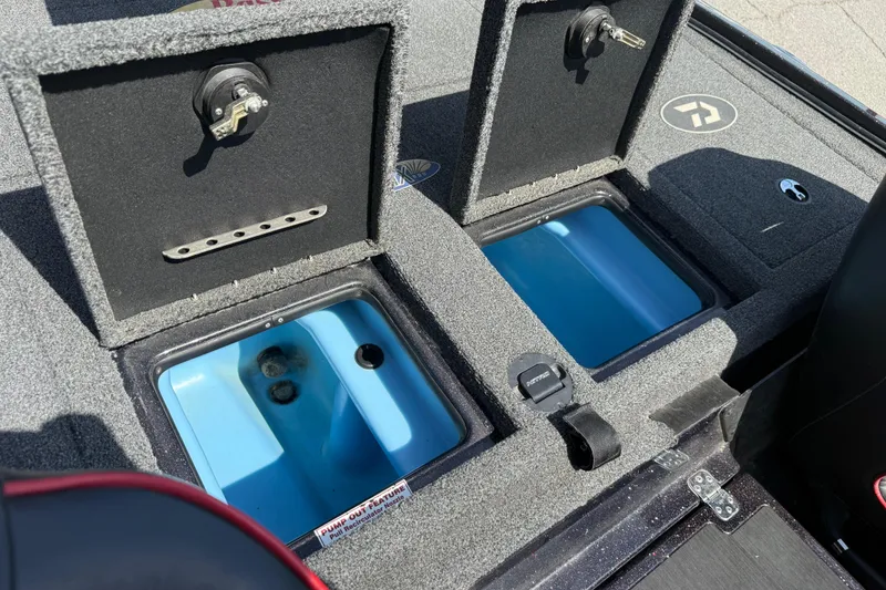 Slide: The Image of 2021 Nitro Z20 boat storage compartments with open lids and blue interior. - 104