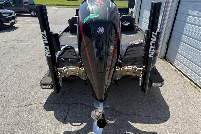Slide: The Image of Rear view of a 2021 Nitro Z20 boat with Talon anchors in a parking area. - 84