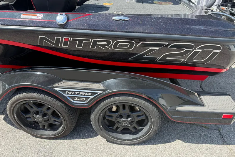 Slide: The Image of 2021 Nitro Z20 boat trailer with black and red design, featuring dual wheels. - 87