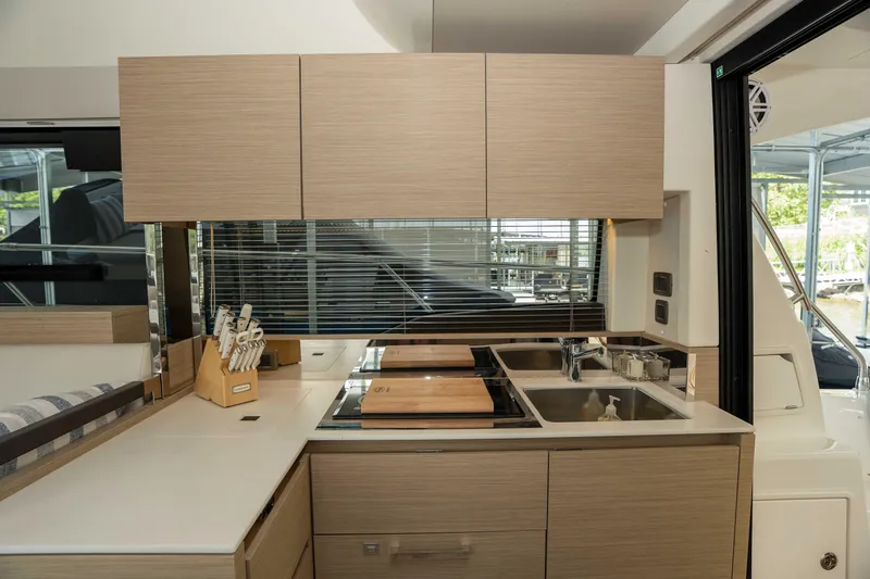 Slide: The Image of Modern kitchen interior on 2025 Pacific Prestige 460 Fly yacht, featuring sleek cabinetry and appliances. - 51