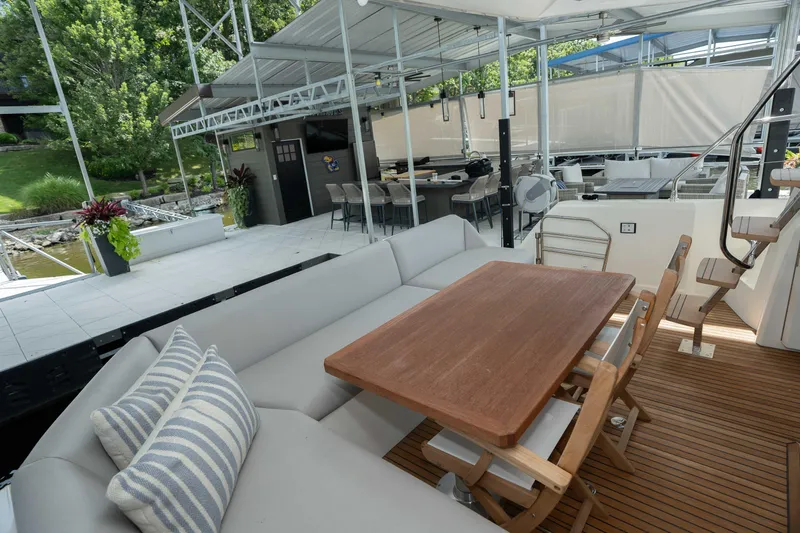 Slide: The Image of Luxurious 2025 Pacific Prestige 460 Fly yacht with elegant outdoor seating and dining area. - 22
