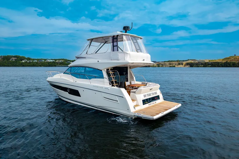 Slide: The Image of 2025 Pacific Prestige 460 Fly yacht cruising on a serene blue lake. - 4