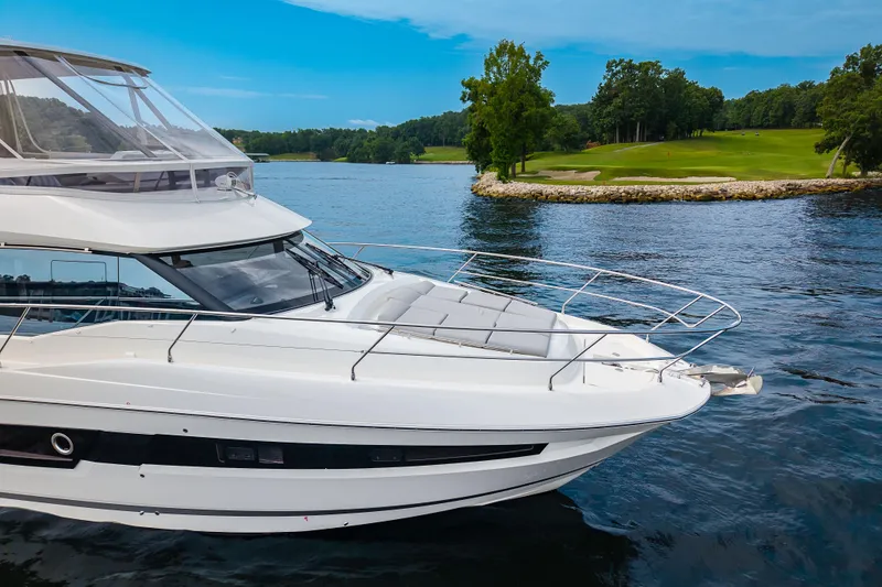 Slide: The Image of Luxury 2025 Pacific Prestige 460 Fly yacht cruising on a serene lake. - 8