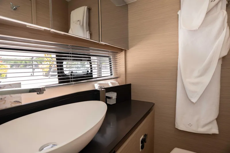 Slide: The Image of Luxurious bathroom interior of 2025 Pacific Prestige 460 Fly yacht with modern sink and window. - 35