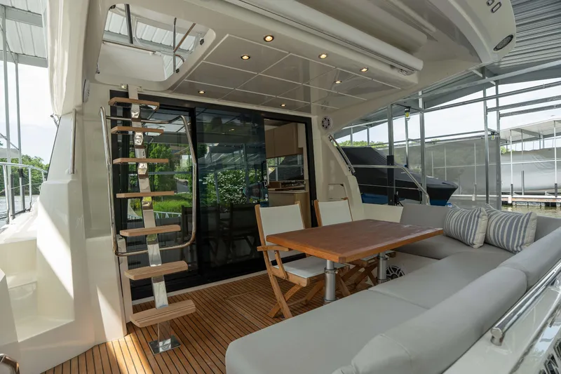 Slide: The Image of Luxurious 2025 Pacific Prestige 460 Fly yacht interior with seating and dining area. - 24