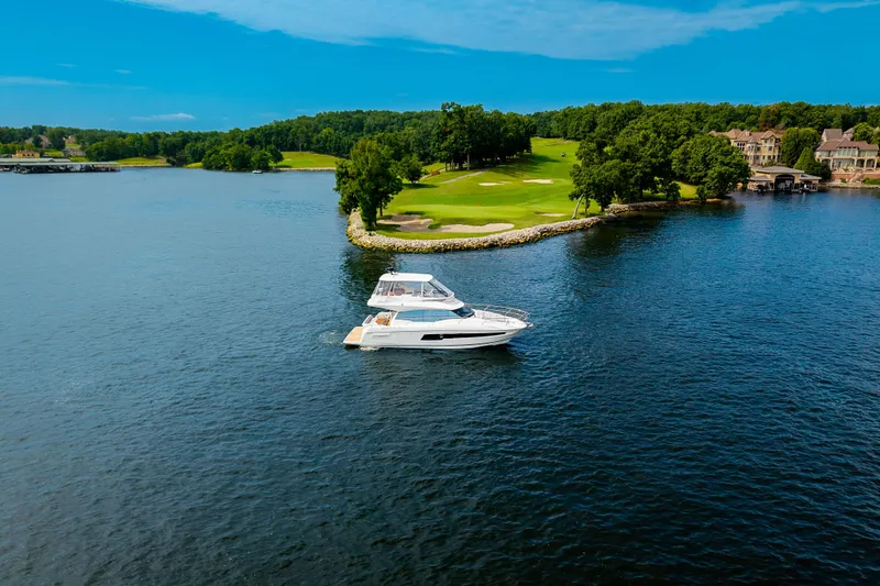 Slide: The Image of Luxury 2025 Pacific Prestige 460 Fly yacht cruising near scenic shoreline. - 15