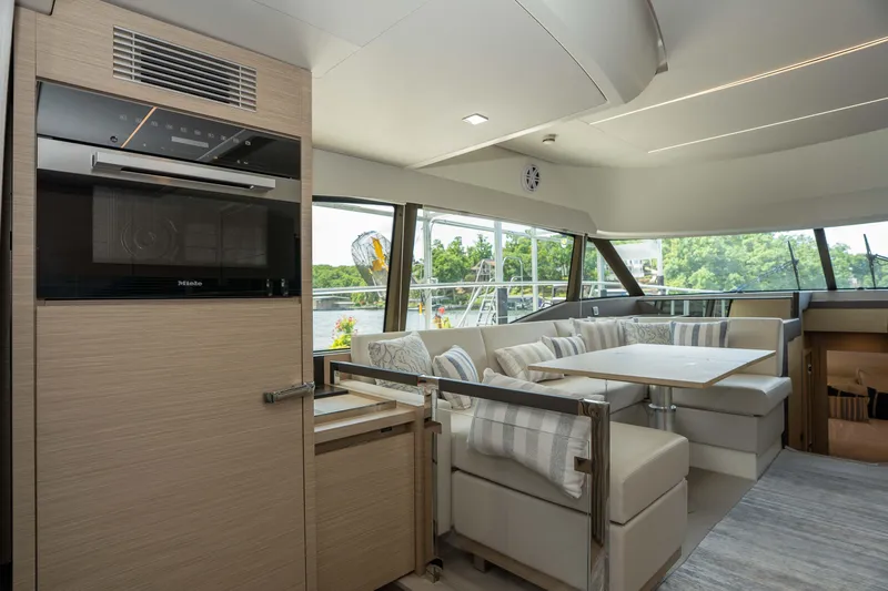 Slide: The Image of Luxurious interior of 2025 Pacific Prestige 460 Fly yacht with modern seating and large windows. - 50