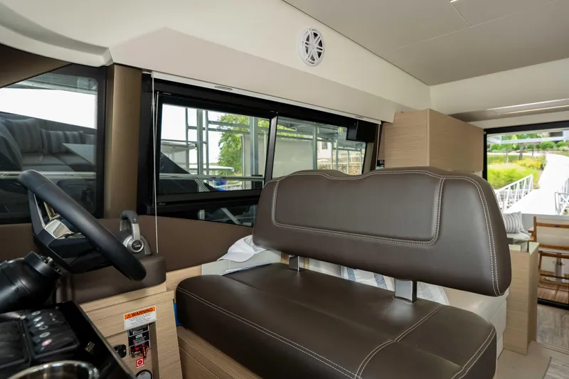 Slide: The Image of Interior of 2025 Pacific Prestige 460 Fly yacht with leather seating and modern controls. - 53