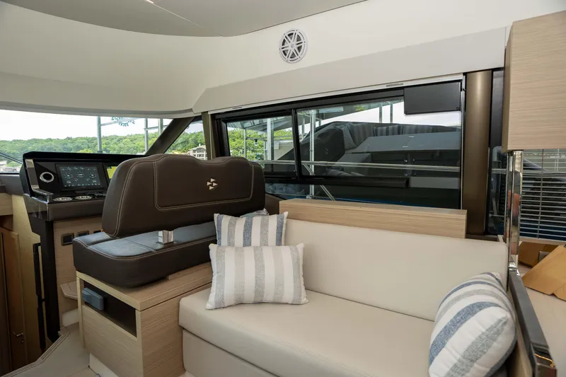 Slide: The Image of Interior of 2025 Pacific Prestige 460 Fly yacht with modern seating and navigation controls. - 47