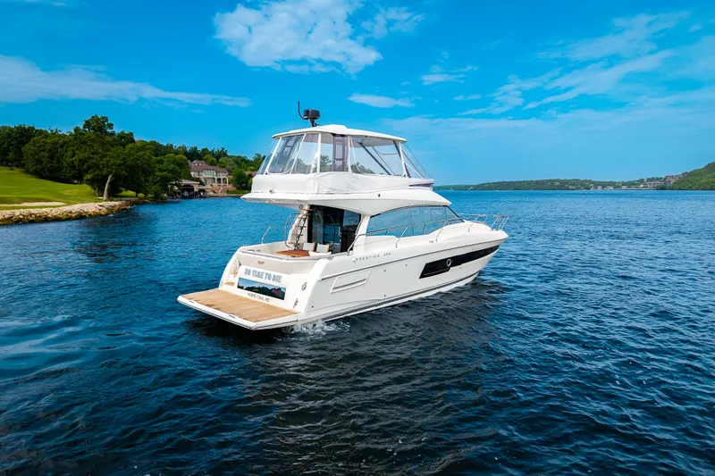 Slide: The Image of Luxury Pacific Prestige 460 Fly yacht cruising on a serene lake, 2025 model. - 5