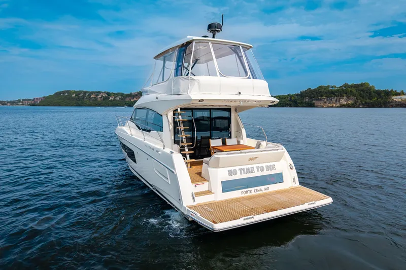 Slide: The Image of Luxury 2025 Pacific Prestige 460 Fly yacht cruising on a serene lake. - 3
