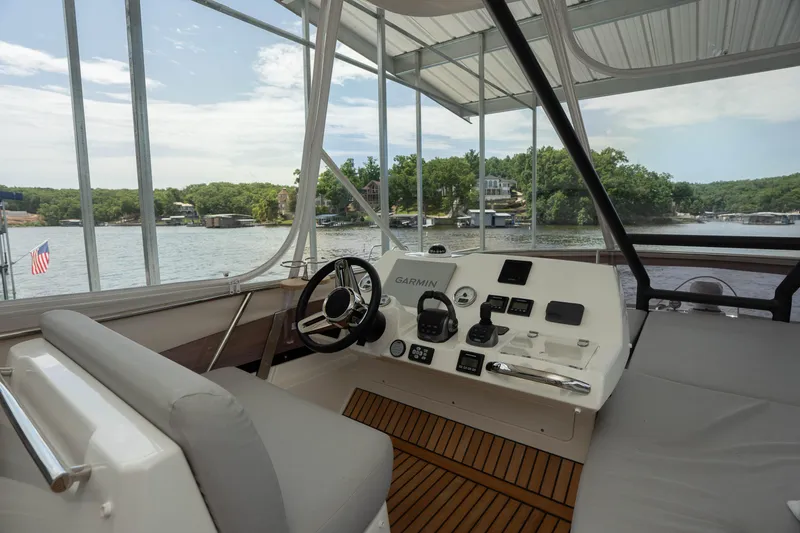 Slide: The Image of Helm of 2025 Pacific Prestige 460 Fly yacht with scenic lake view. - 29