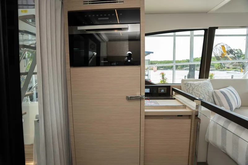 Slide: The Image of Interior of 2025 Pacific Prestige 460 Fly yacht with modern kitchen and seating area. - 44