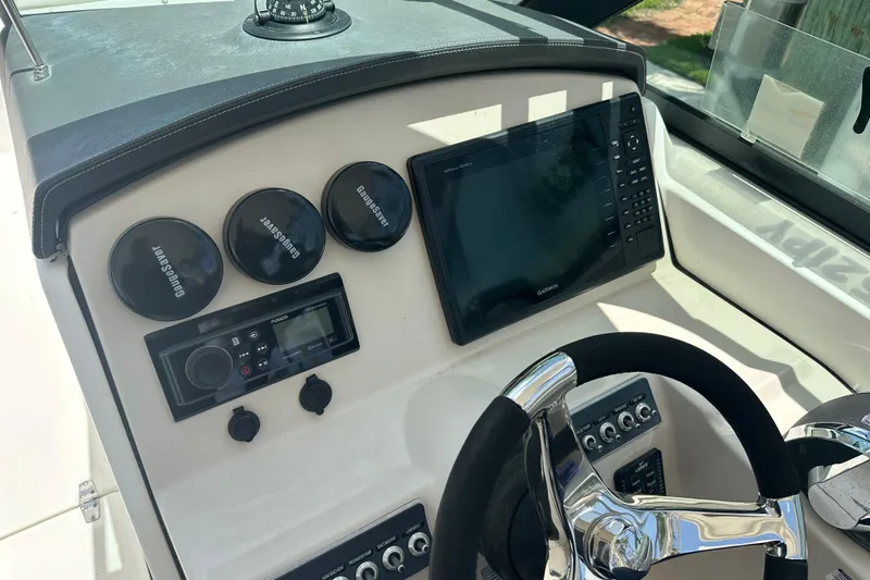Slide: The Image of 2015 Boston Whaler 270 Vantage dashboard with Garmin display and steering wheel. - 21