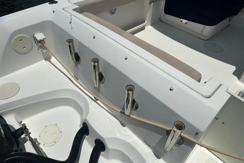 Slide: The Image of 2015 Boston Whaler 270 Vantage boat interior with rod holders and seating area. - 14