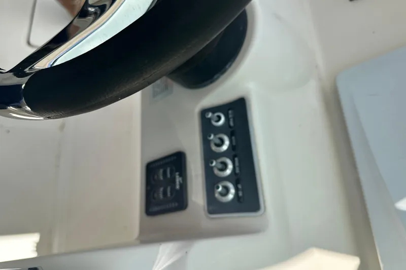 Slide: The Image of Steering wheel and control panel of 2015 Boston Whaler 270 Vantage boat. - 23