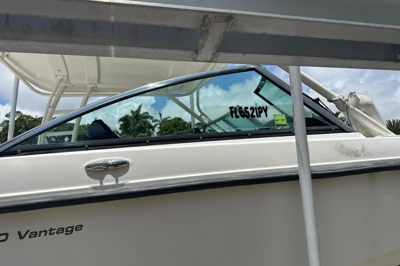 Slide: The Image of 2015 Boston Whaler 270 Vantage boat docked, side view with registration number visible. - 9