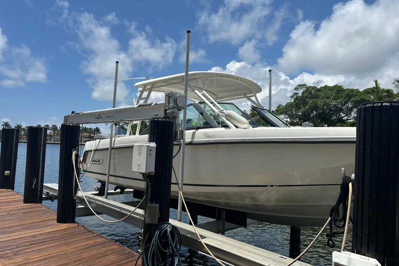 Slide: The Image of 2015 Boston Whaler 270 Vantage boat docked under a clear blue sky. - 5