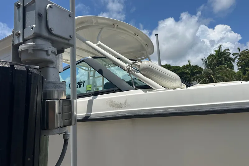 Slide: The Image of 2015 Boston Whaler 270 Vantage boat docked under a clear blue sky. - 7