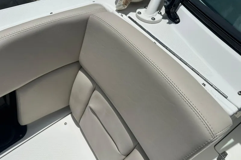 Slide: The Image of 2015 Boston Whaler 270 Vantage boat interior with beige seating and white deck. - 30