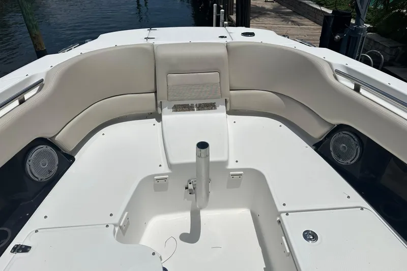 Slide: The Image of 2015 Boston Whaler 270 Vantage boat interior with cushioned seating and speakers. - 28