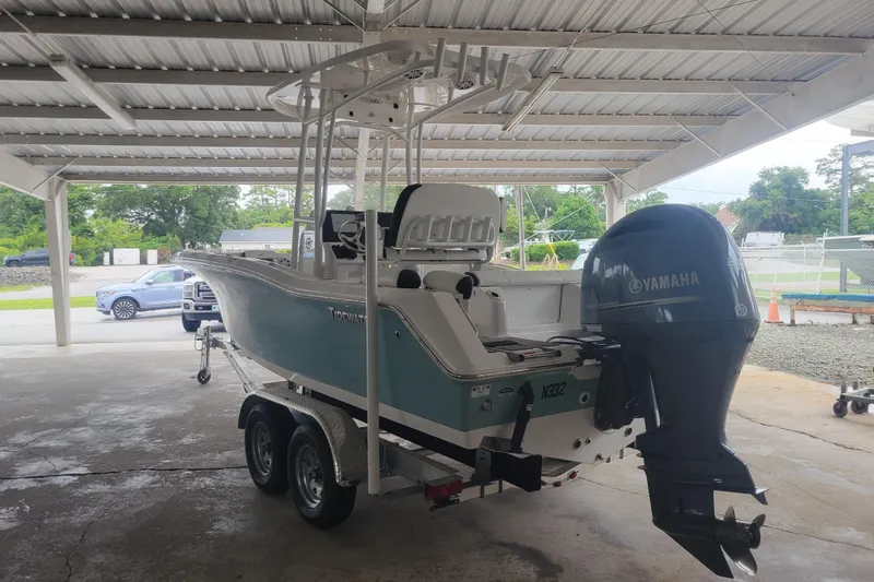 Slide: The Image of 2023 Tidewater 210 LXF boat with Yamaha outboard motor under a metal canopy. - 1